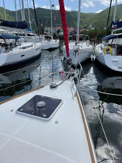 Hygge Yacht Photos Pics 2017 Jeanneau Sun Odyssey 479 sailboat docked in a marina, surrounded by other boats.