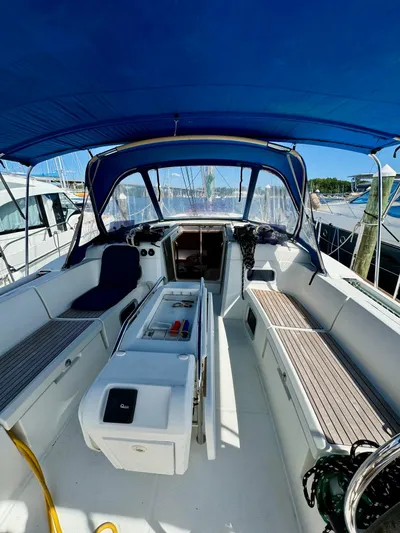 Hygge Yacht Photos Pics 2017 Jeanneau Sun Odyssey 479 sailboat cockpit with blue canopy and seating.