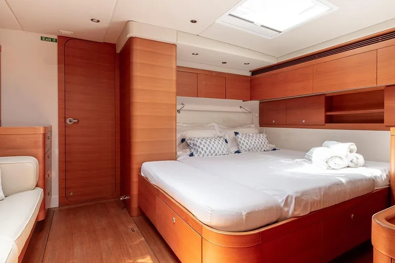 Caiarossa Yacht Photos Pics Luxurious cabin interior of 2009 Seaway Shipman 72 yacht with wooden finishes and cozy bedding.