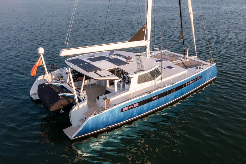 Ondine Blue Yacht Photos Pics Sleek 2016 Balance 526 catamaran with solar panels, sailing on calm waters.
