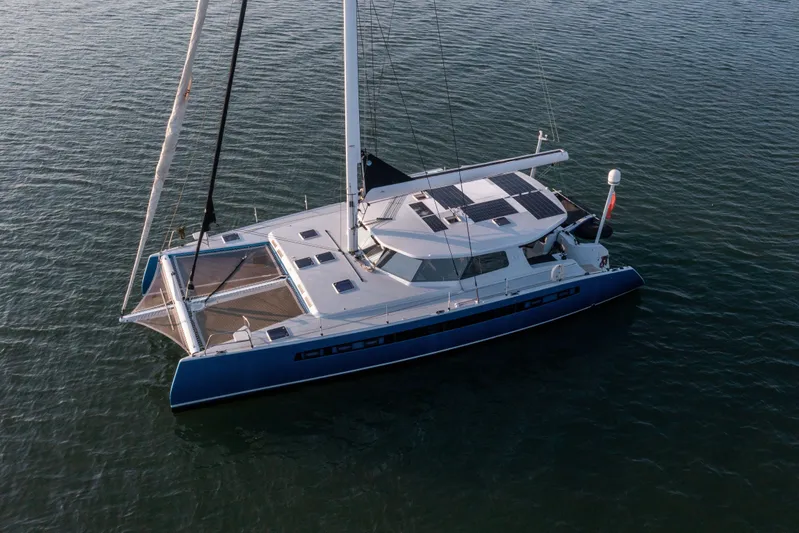 Ondine Blue Yacht Photos Pics Sleek 2016 Balance 526 catamaran sailing on calm waters, featuring solar panels.