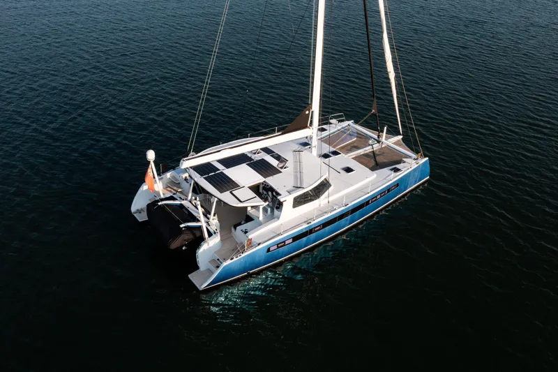 Ondine Blue Yacht Photos Pics Aerial view of 2016 Balance 526 catamaran sailing on calm waters.