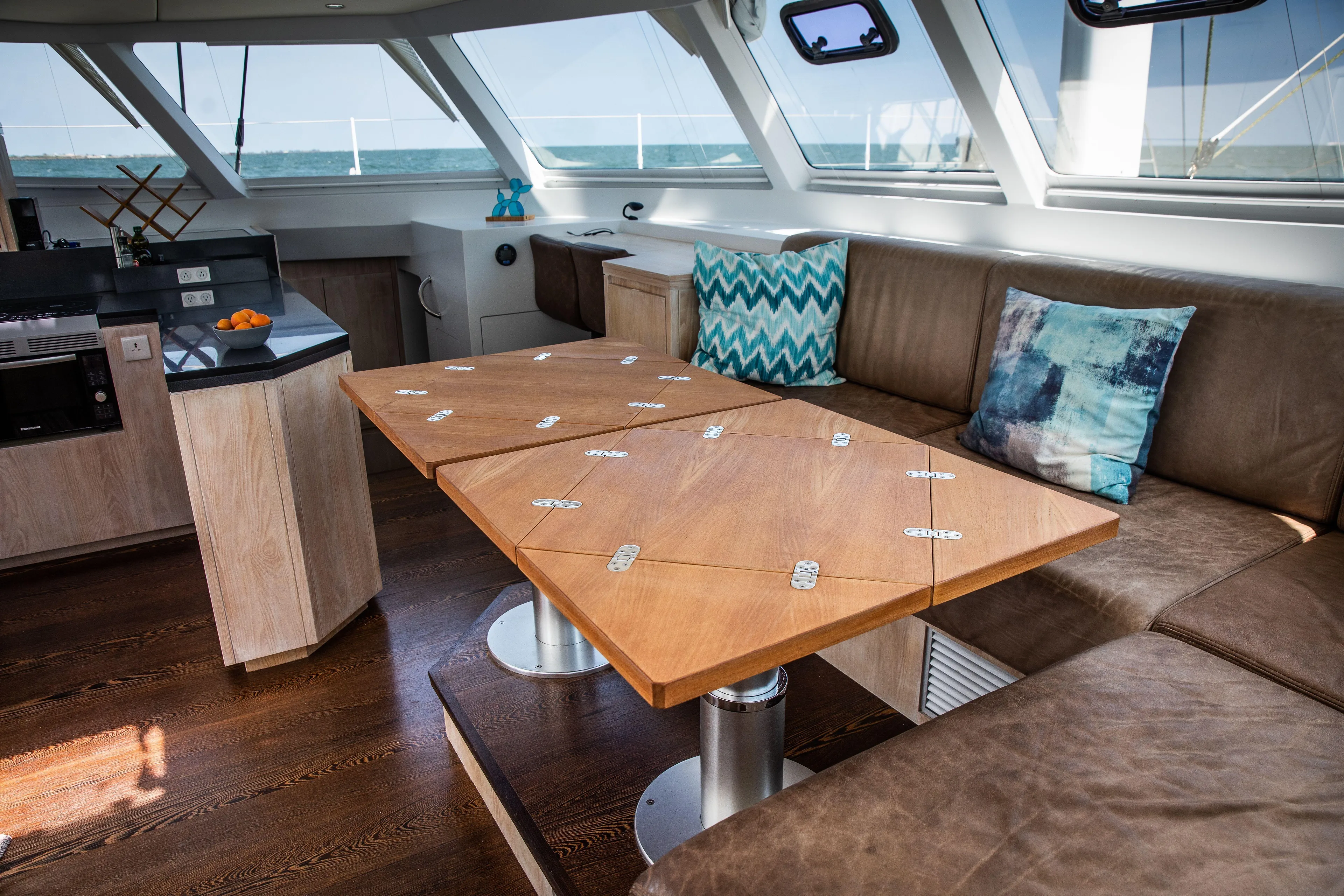 Ondine Blue Yacht Photos Pics Luxurious interior of 2016 Balance 526 yacht with modern seating and wooden table.