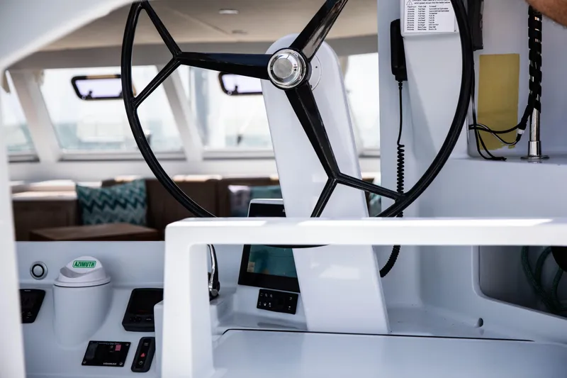 Ondine Blue Yacht Photos Pics Steering wheel of a 2016 Balance 526 yacht, featuring modern navigation controls.