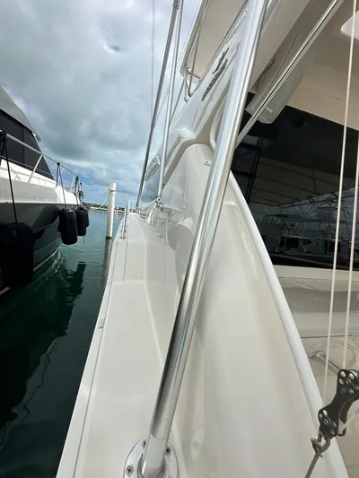  Yacht Photos Pics Side view of a 2002 Bertram 510 Convertible yacht docked at a marina.