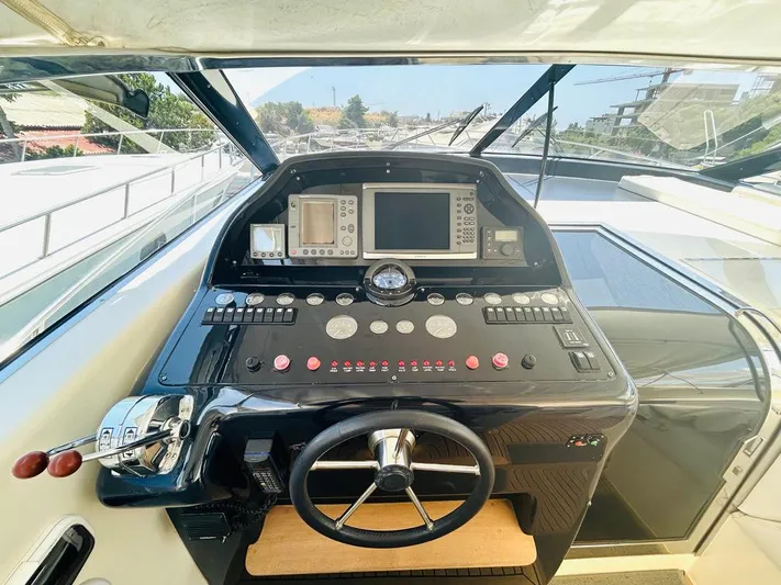 Yacht Photos Pics Helm of 2000 Uniesse 57 yacht with navigation controls and steering wheel.
