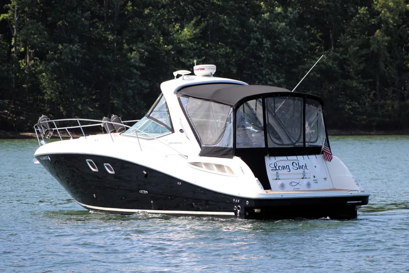  Yacht Photos Pics 2008 Sea Ray 330 Sundancer boat cruising on a lake with forested background.