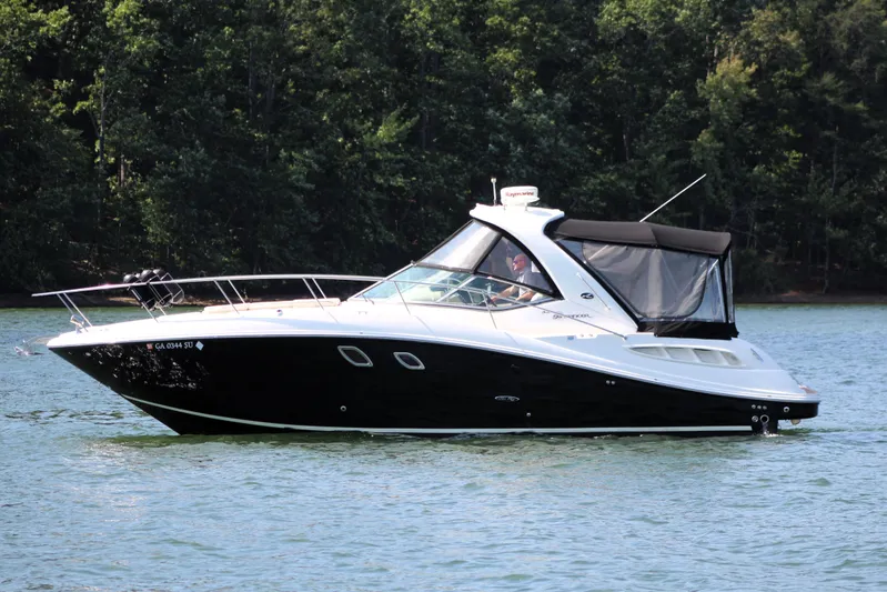  Yacht Photos Pics 2008 Sea Ray 330 Sundancer boat on a serene lake with forest backdrop.