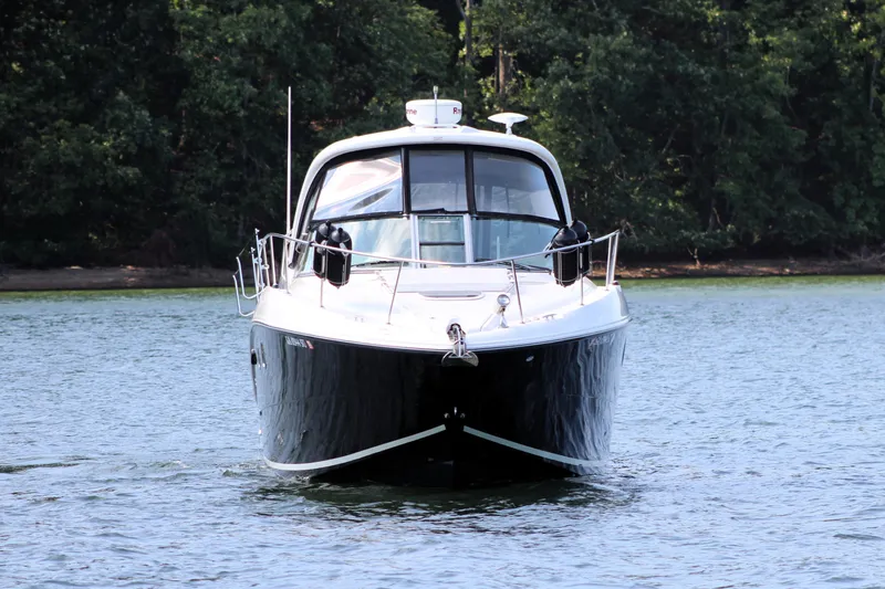  Yacht Photos Pics 2008 Sea Ray 330 Sundancer yacht on calm water, surrounded by lush greenery.
