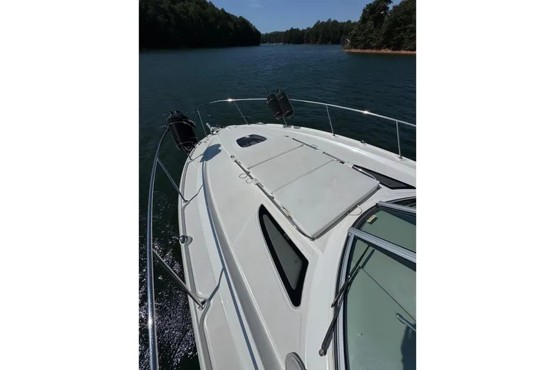  Yacht Photos Pics 2008 Sea Ray 330 Sundancer cruising on a serene lake with lush forested shoreline.