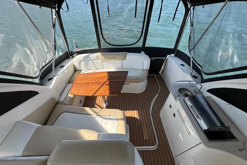  Yacht Photos Pics Interior of 2008 Sea Ray 330 Sundancer with seating, table, and kitchenette.