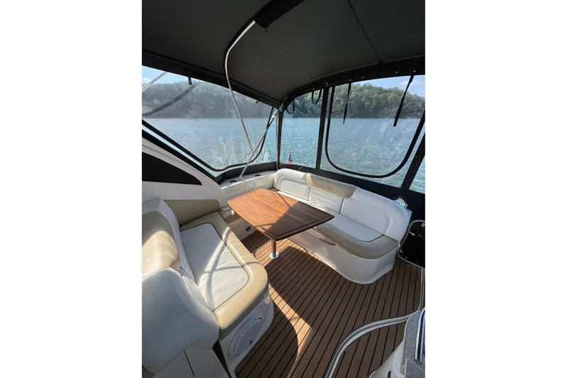  Yacht Photos Pics 2008 Sea Ray 330 Sundancer interior with seating and table, overlooking serene water view.
