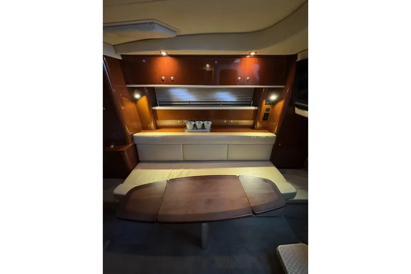  Yacht Photos Pics Interior of 2008 Sea Ray 330 Sundancer yacht with wooden table and seating area.