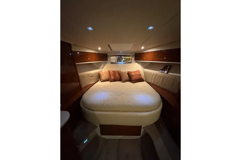  Yacht Photos Pics Luxurious interior cabin of 2008 Sea Ray 330 Sundancer with cozy bedding and ambient lighting.