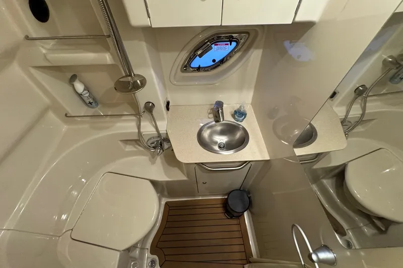  Yacht Photos Pics Bathroom interior of 2008 Sea Ray 330 Sundancer yacht with sink, toilet, and shower.