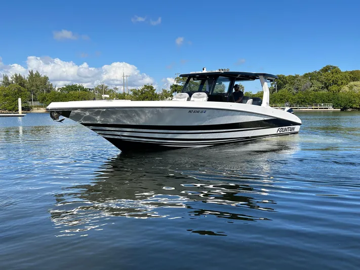  Yacht Photos Pics 2023 Fountain 38 SCX boat on calm water under a clear blue sky.