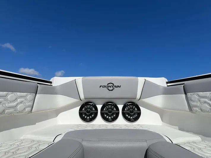  Yacht Photos Pics 2023 Fountain 38 SCX boat interior with speakers and logo against blue sky.