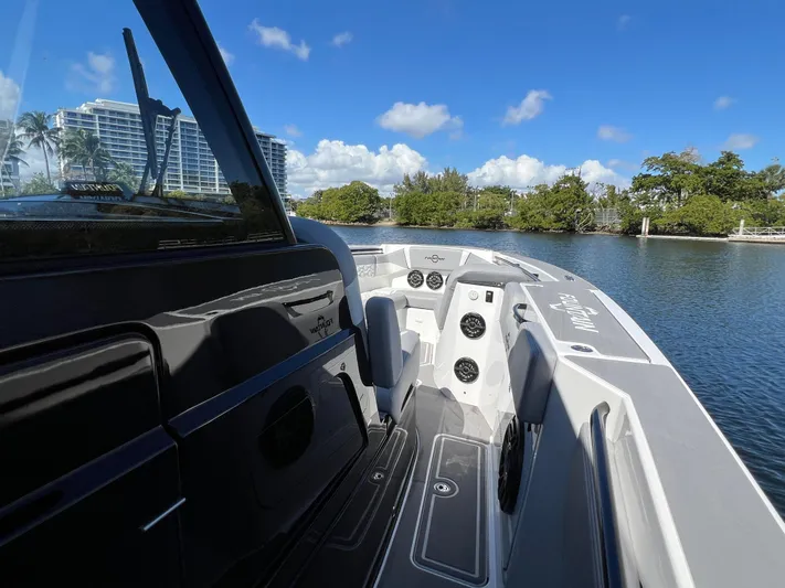  Yacht Photos Pics 2023 Fountain 38 SCX boat on calm water with clear blue sky.