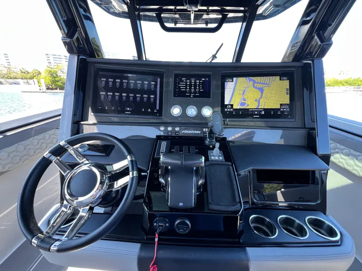  Yacht Photos Pics 2023 Fountain 38 SCX boat dashboard with navigation screens and controls.