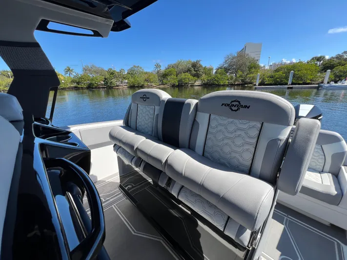  Yacht Photos Pics 2023 Fountain 38 SCX boat interior with luxurious seating by a serene waterway.