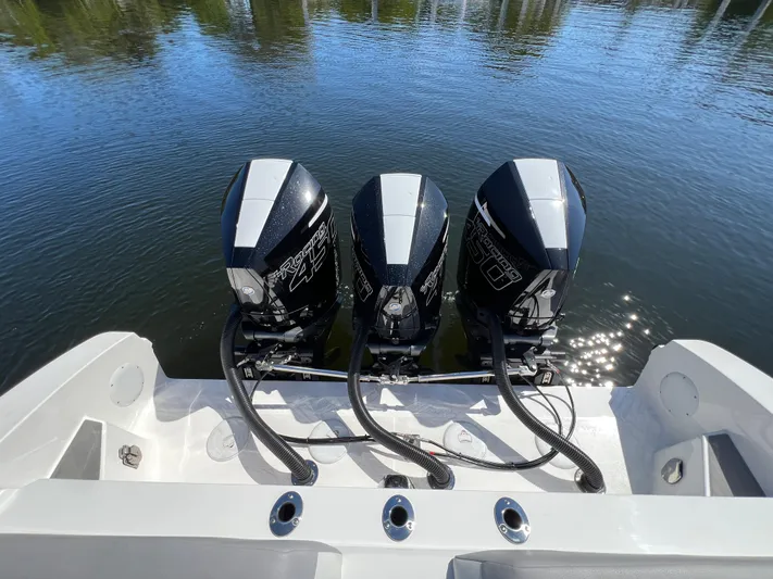  Yacht Photos Pics 2023 Fountain 38 SCX boat with triple outboard engines on calm water.