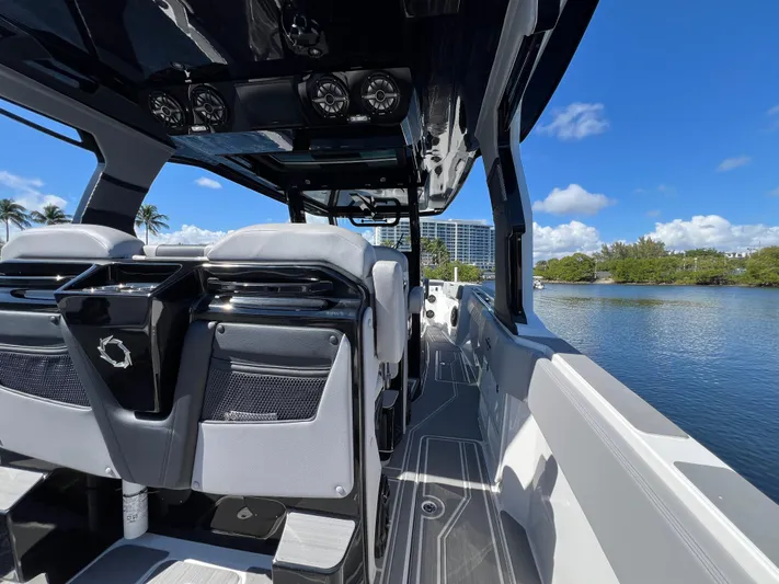  Yacht Photos Pics 2023 Fountain 38 SCX boat interior with sleek design, overlooking a serene waterway.