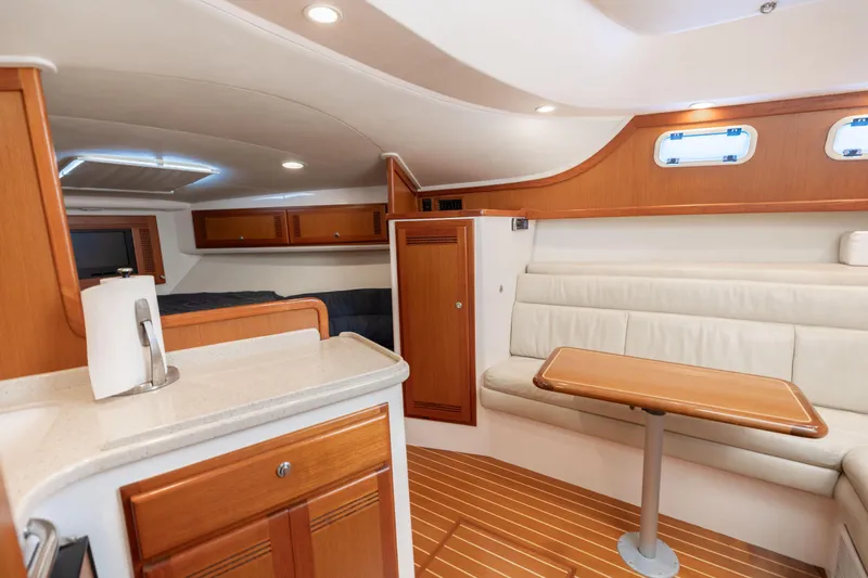 Miss Big Gun Yacht Photos Pics Interior of 2000 Cabo 35 Express yacht with wood accents and cozy seating area.