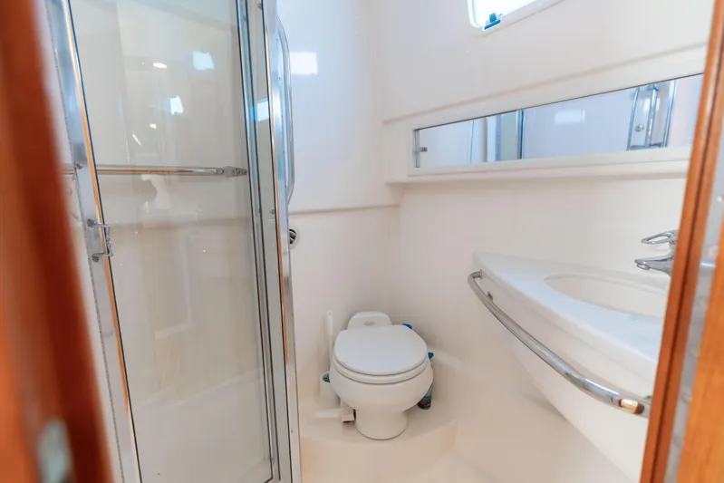 Miss Big Gun Yacht Photos Pics Bathroom interior of 2000 Cabo 35 Express yacht with shower and toilet.