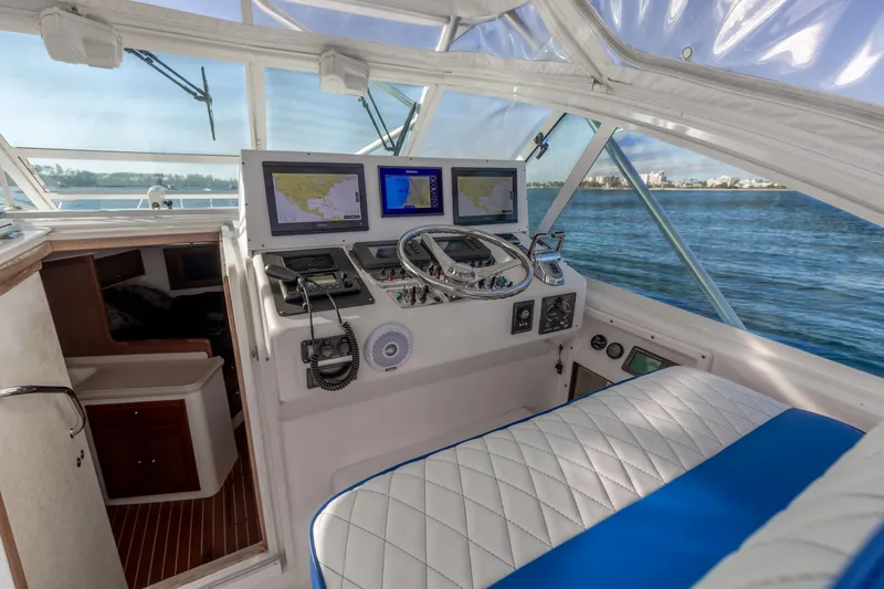 Miss Big Gun Yacht Photos Pics Interior of 2000 Cabo 35 Express boat with navigation equipment and seating.