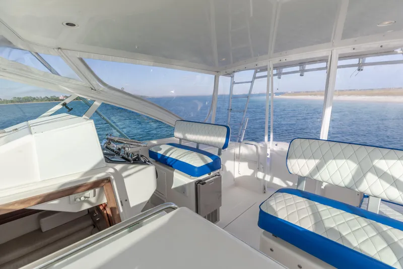Miss Big Gun Yacht Photos Pics Interior of 2000 Cabo 35 Express boat with blue and white seating, ocean view.