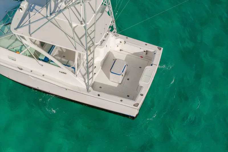 Miss Big Gun Yacht Photos Pics 2000 Cabo 35 Express boat on turquoise water, aerial view.