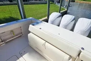  Yacht Photos Pics 2022 Grady-White Canyon 336 boat with triple engines docked by the water.