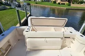  Yacht Photos Pics 2022 Grady-White Canyon 336 boat interior with open storage compartment by a waterfront.