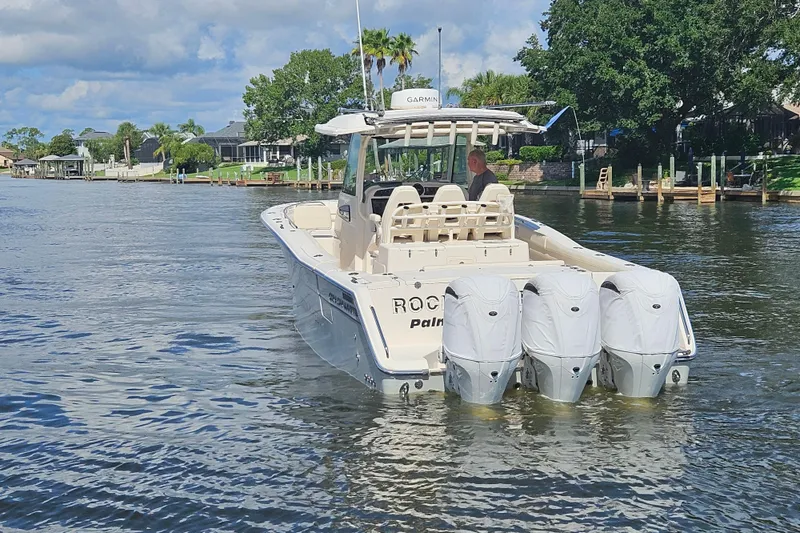  Yacht Photos Pics 2022 Grady-White Canyon 336 boat cruising on a scenic waterway with triple engines.