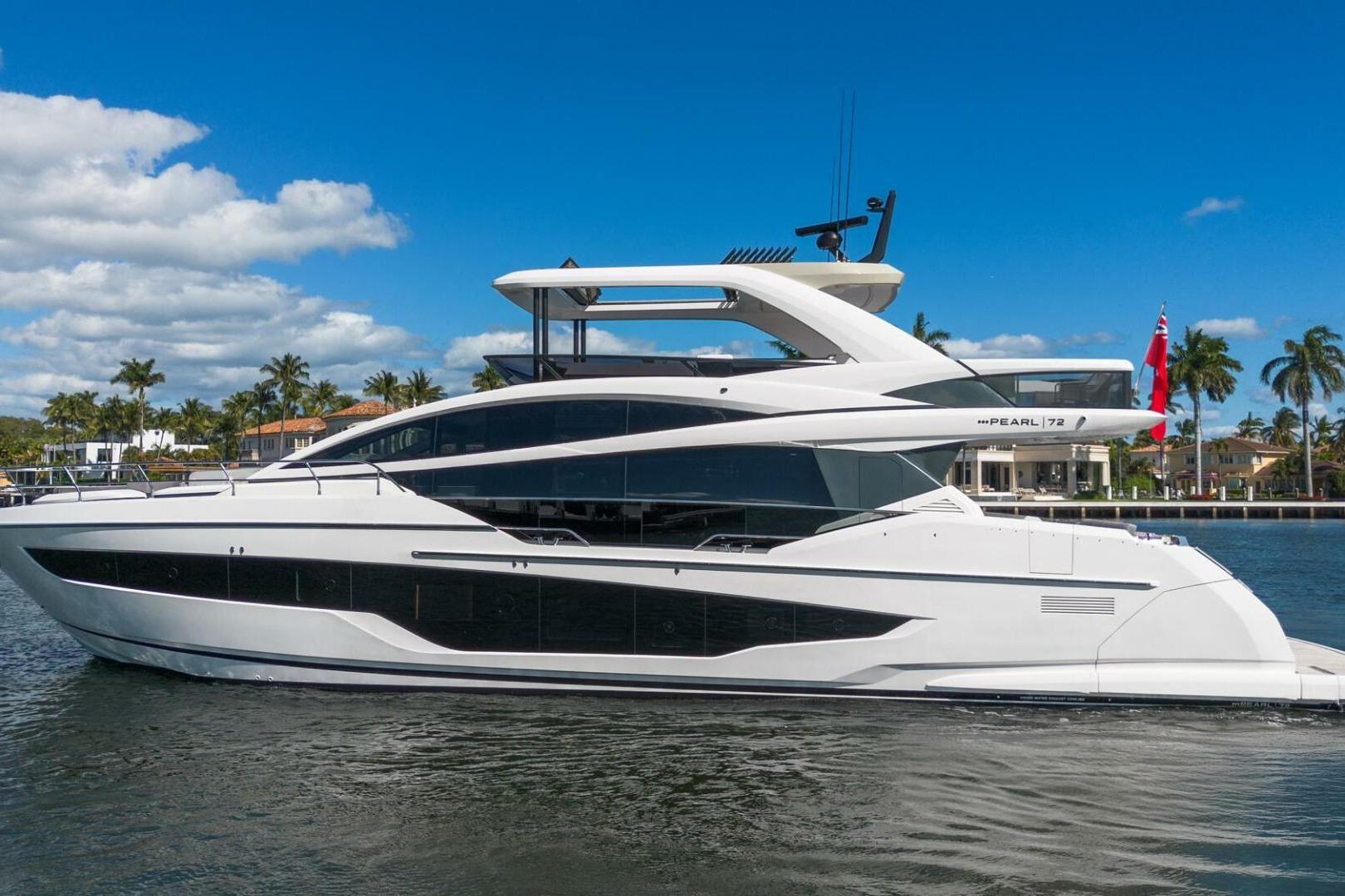 Luxurious 2025 Pearl 72 yacht cruising on a sunny day, surrounded by palm trees.