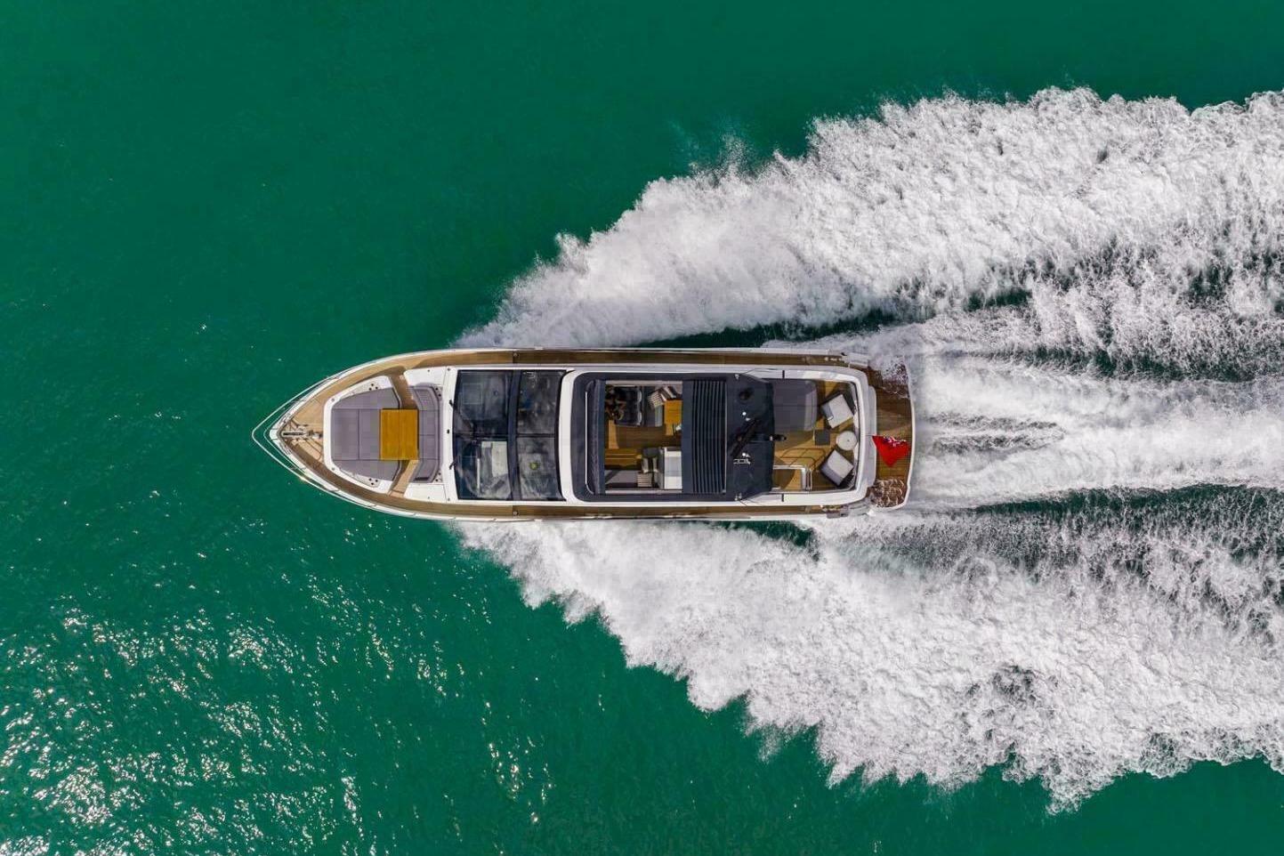 Aerial view of 2025 Pearl 72 yacht cruising on turquoise water.