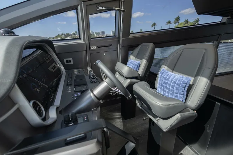 Pearl 72 Indulgence Yacht Photos Pics Interior of 2025 Pearl 72 yacht cockpit with modern controls and plush seating.
