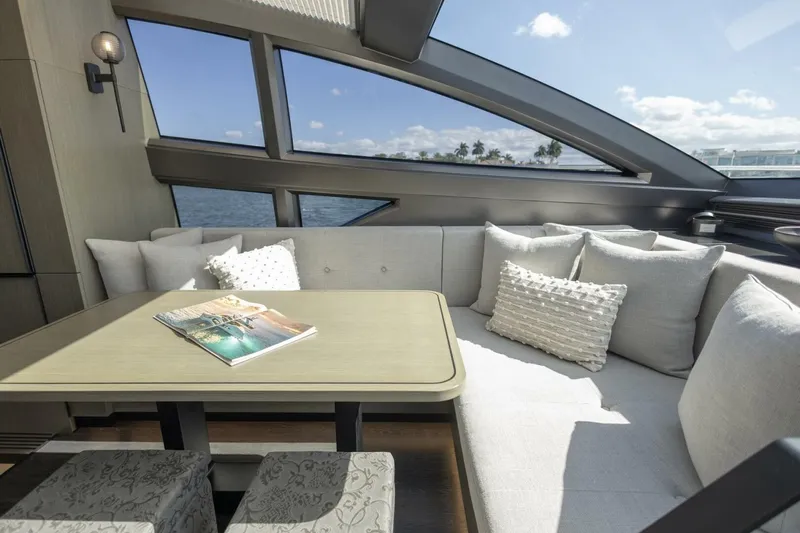 Pearl 72 Indulgence Yacht Photos Pics Luxurious interior of 2025 Pearl 72 yacht with elegant seating and scenic windows.