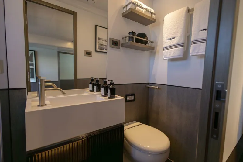 Pearl 72 Indulgence Yacht Photos Pics Modern bathroom in Pearl 72 yacht, featuring sleek sink, towels, and elegant decor, 2025 model.