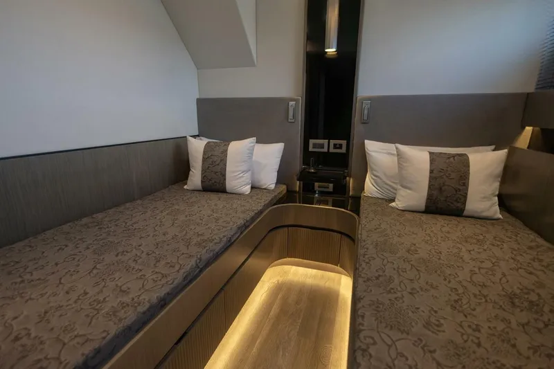 Pearl 72 Indulgence Yacht Photos Pics Luxurious twin cabin interior of 2025 Pearl 72 yacht with elegant bedding and ambient lighting.