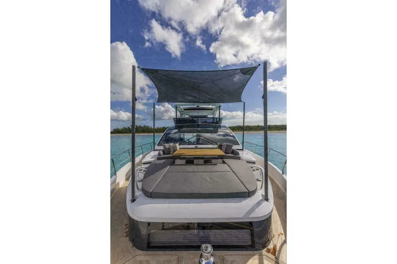 Pearl 72 Indulgence Yacht Photos Pics Luxury Pearl 72 yacht, 2025 model, with sunshade on open deck, under blue sky.