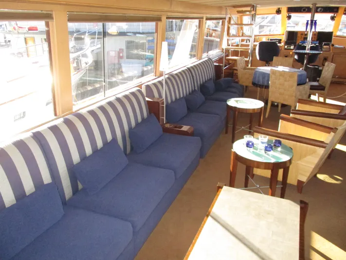 Accord Yacht Photos Pics Luxurious interior of 1984 McQueen Flush Deck Motoryacht with blue seating and elegant decor.