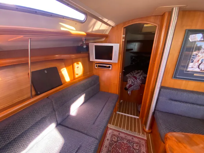First Admiral Yacht Photos Pics Interior of a 2006 Hunter 38 yacht with cozy sofa and TV.