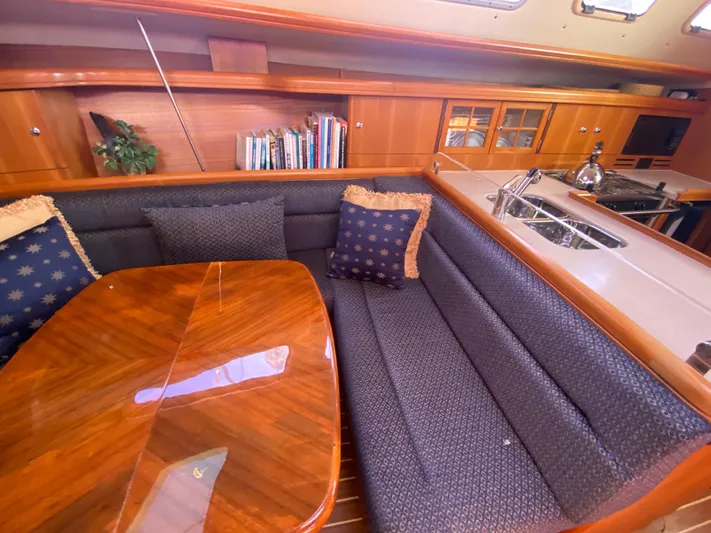 First Admiral Yacht Photos Pics Interior of a 2006 Hunter 38 yacht with cozy seating area.