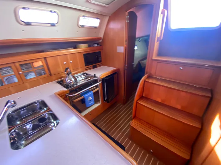 First Admiral Yacht Photos Pics Interior of a 2006 Hunter 38 yacht with kitchen and stairs.
