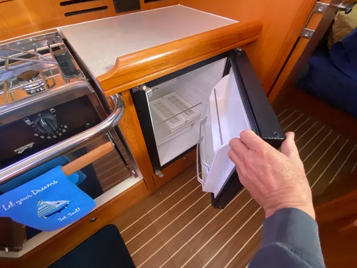 First Admiral Yacht Photos Pics Galley area of a 2006 Hunter 38 yacht with open fridge.