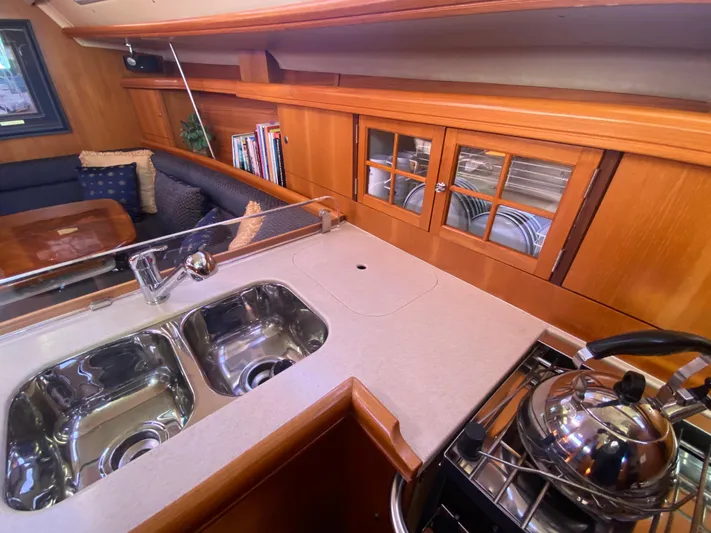First Admiral Yacht Photos Pics Interior of 2006 Hunter 38 yacht with kitchen and sink.