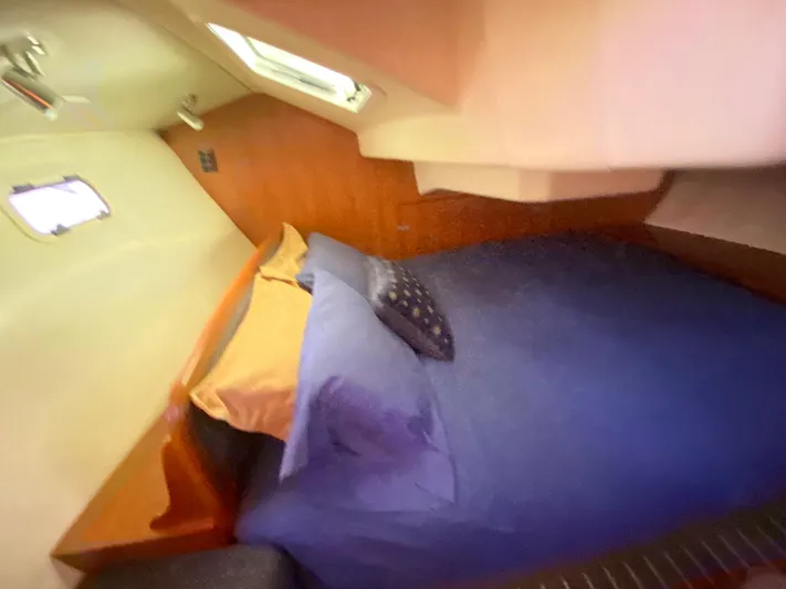 First Admiral Yacht Photos Pics Interior of a 2006 Hunter 38 yacht with a cozy bed.