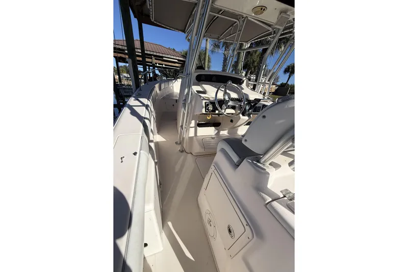 Hooked On A Feeling Yacht Photos Pics 2005 Grady-White Bimini 306 boat interior with steering wheel and seating.