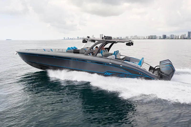  Yacht Photos Pics 2020 Midnight Express 43' Open boat cruising on water, city skyline in background.